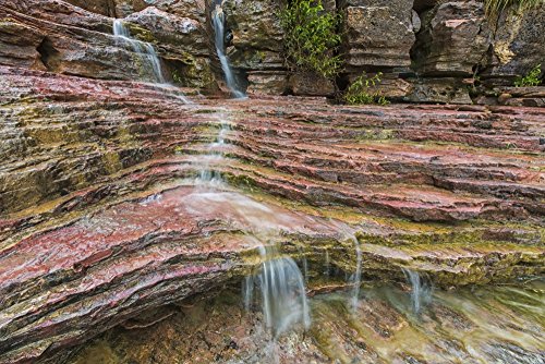 Posterazzi Water flows over a very colourful waterfall in the heart Toro National Park Bolivia Poster Print, (38 x 24)